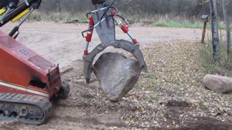 how to move large rocks with a skid steer|how to move rock pipes.